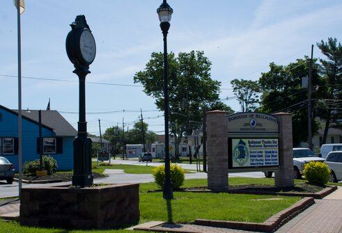 Clock Tower, Street Lamp, and Sign